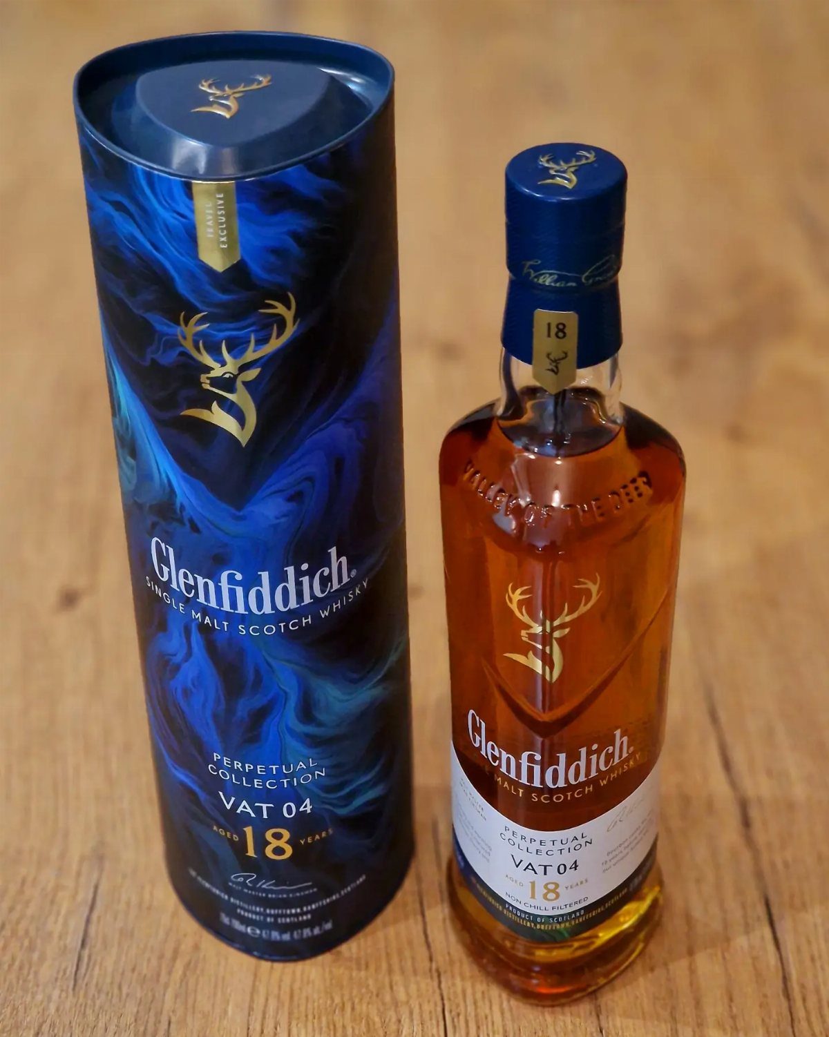 Glenfiddich 18 year old single malt scotch whisky bottle and blue tube packaging.