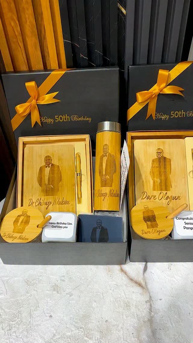 Personalized wooden gift sets with engraved portraits and 50th birthday messages in boxes.
