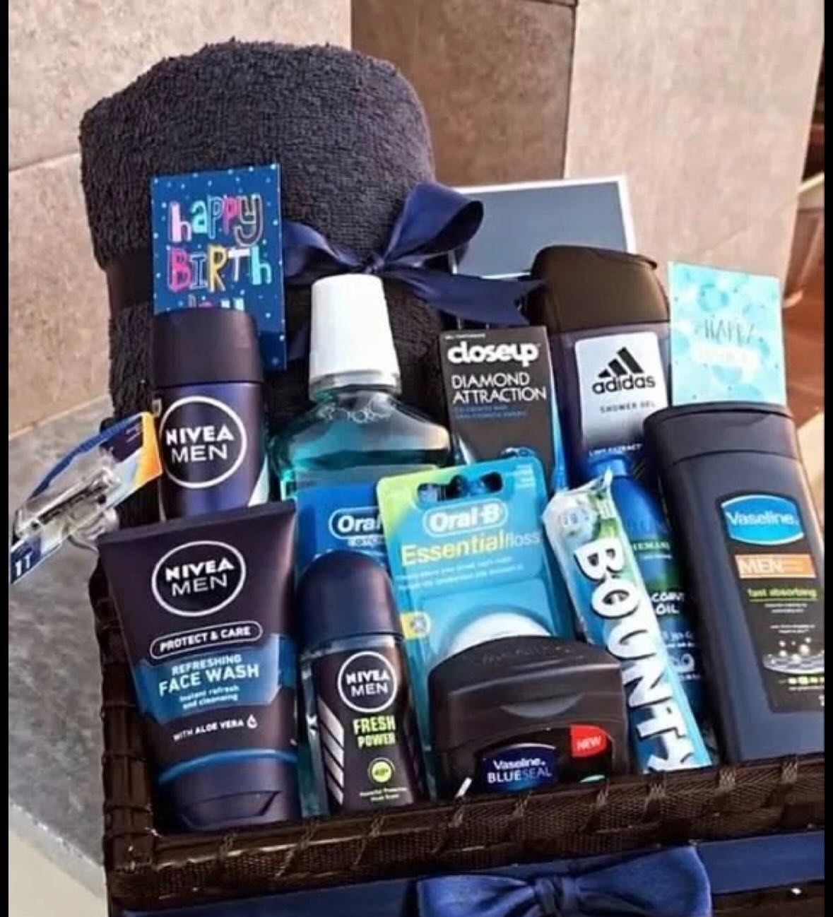 Men's grooming gift basket with toiletries and a Happy Birthday card in wicker