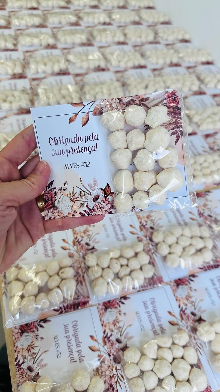 Small clear bags of white candies attached to floral thank you cards.