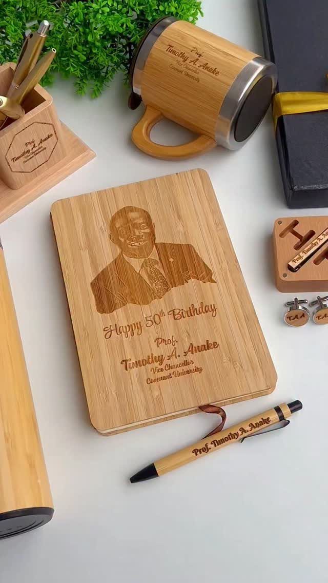 Personalized wooden notebook and office set engraved for a 50th birthday celebration.