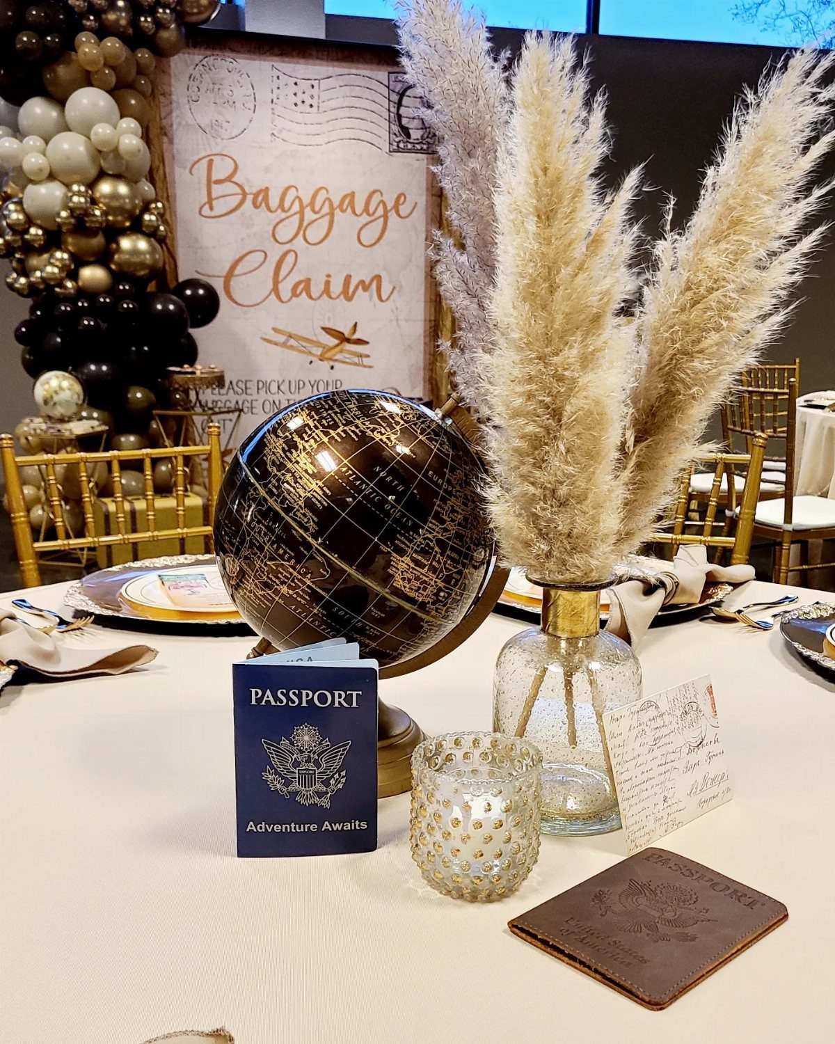 Travel themed table setting with a gold globe, passport, and baggage claim sign.