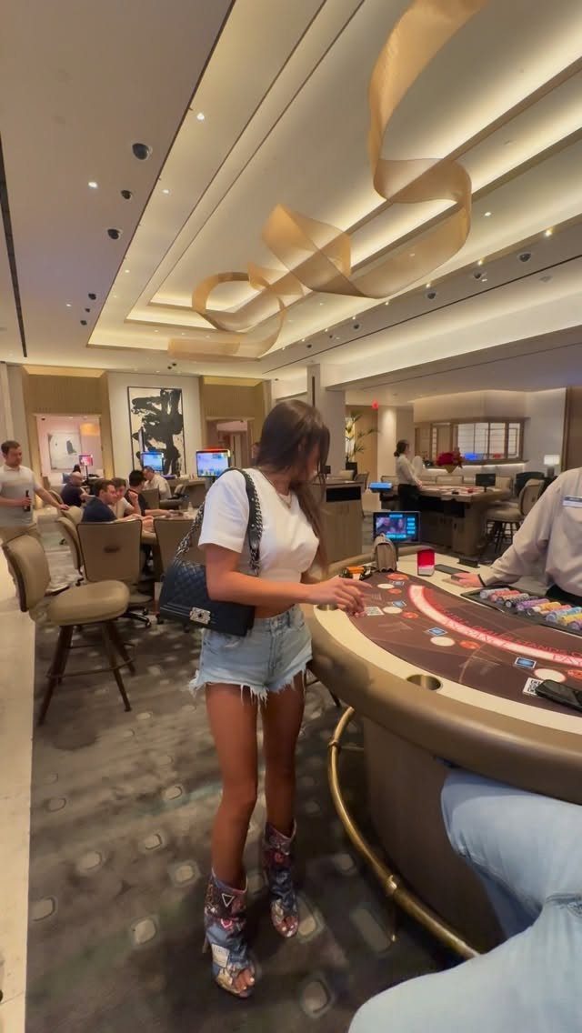 Young woman standing at a casino gaming table inside a Las Vegas casino.