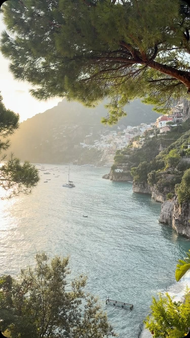 Coastal Mediterranean village with white houses on cliffs overlooking a turquoise bay
