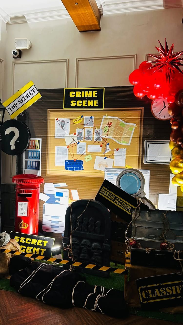 Detective themed party setup with a crime scene board, red balloons, and props.