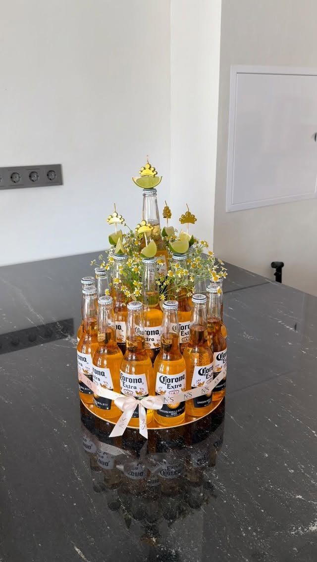 Beer bouquet made of Corona bottles decorated with yellow flowers and lime slices.