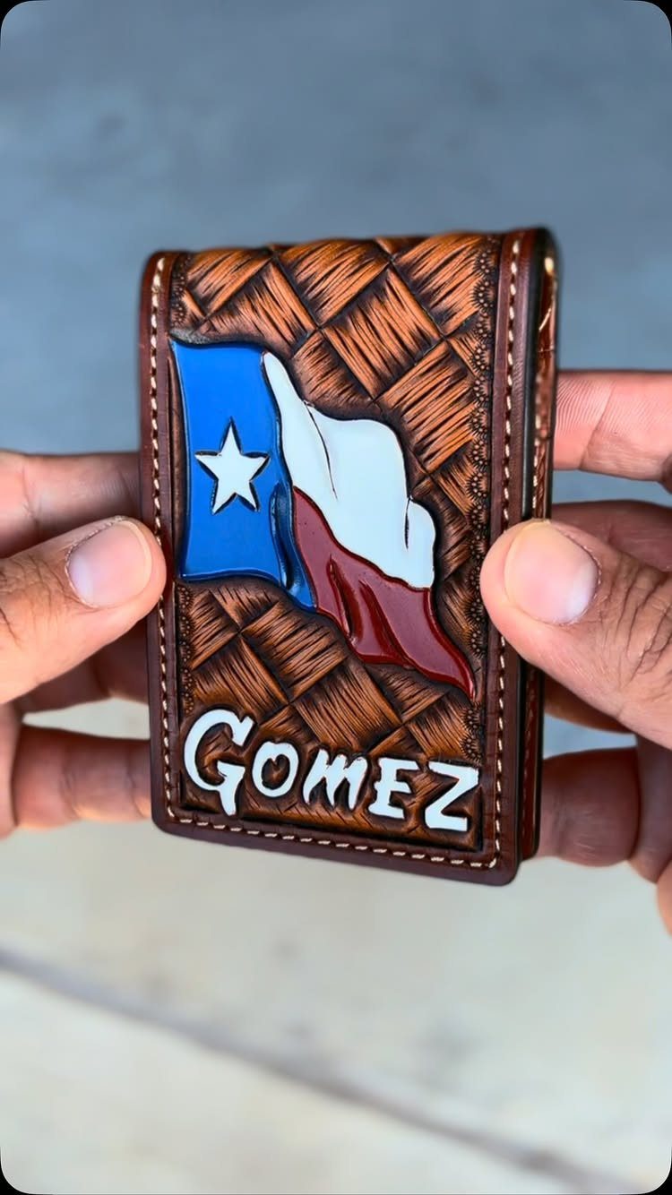 Brown leather wallet with a Texas flag and the name Gomez embossed.