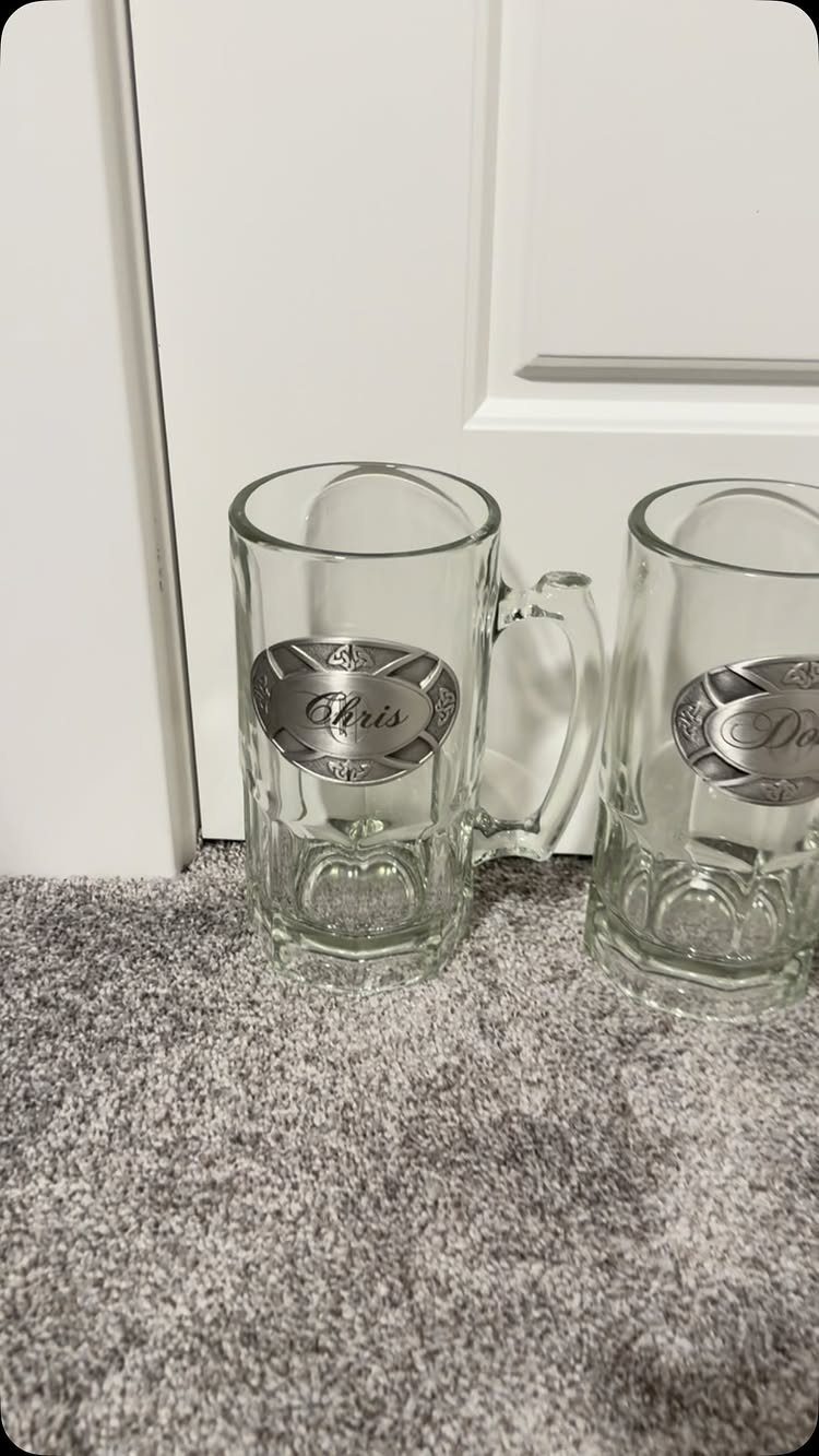 Two glass beer steins with silver plaques engraved with Chris and Dad.