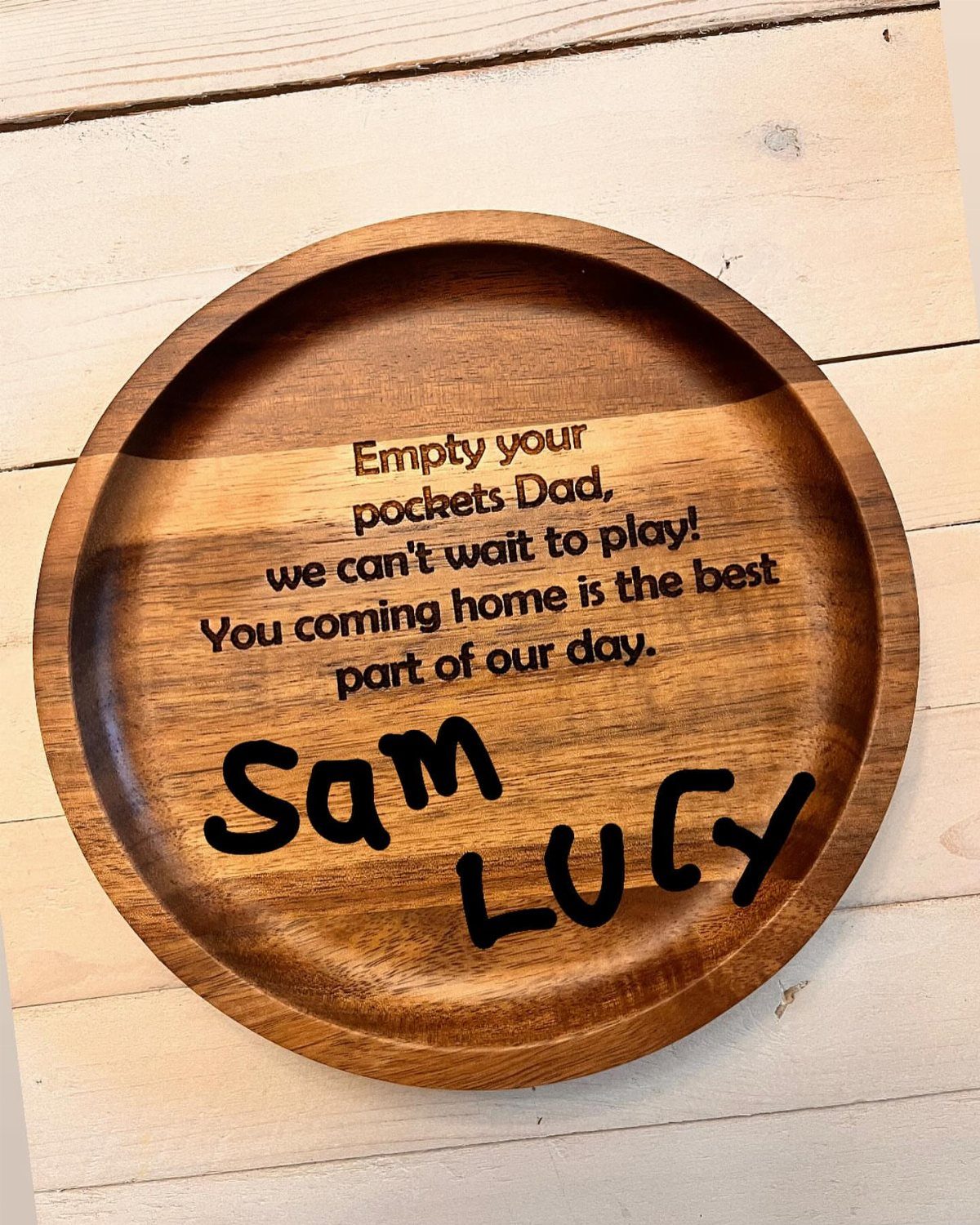 Round wooden valet tray with engraved message for Dad on white wood background