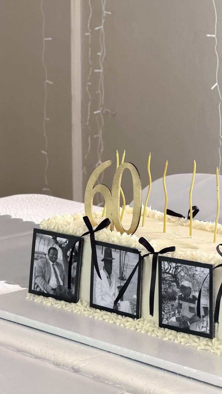 White birthday cake with gold 60 topper and black and white photos.