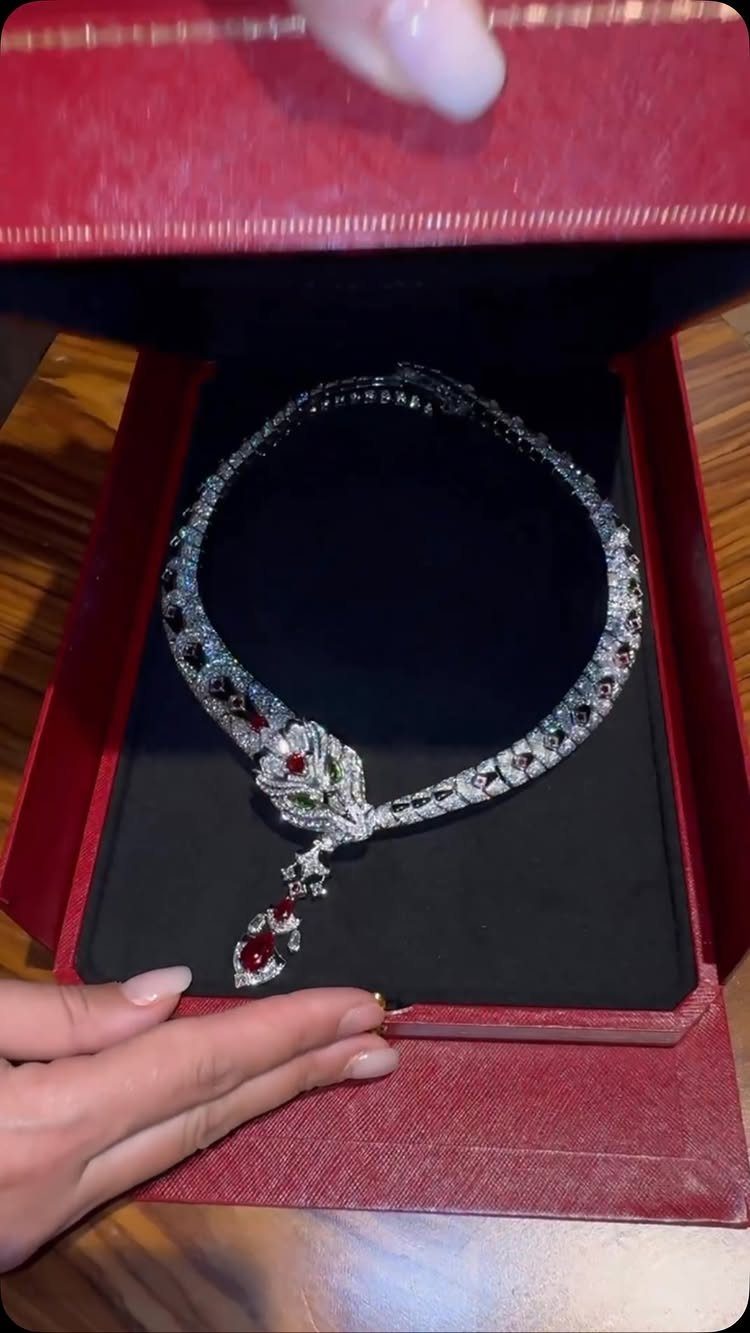 Silver diamond necklace with red rose pendant in a red velvet jewelry box